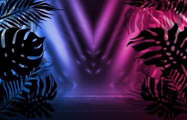Background of empty dark scenes with neon lights and shapes, smoke. Silhouettes of tropical palm leaves in the foreground. Bright futuristic abstract background