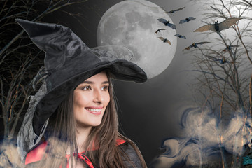  woman model in witch halloween costume over halloween background