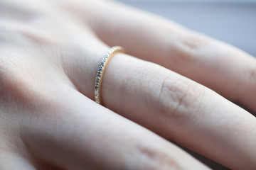 Close up view of woman's hand with wedding ring in sun light