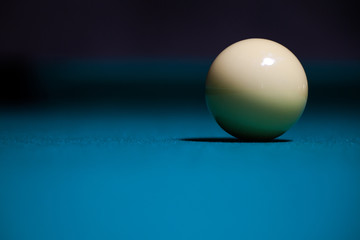Pool white ball alone in table with blue felt