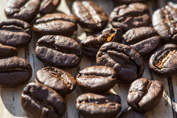 macro roasted coffee beans on wood