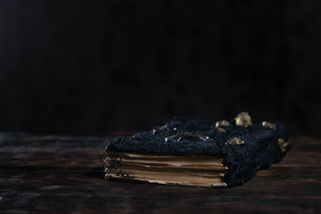 Ancient magic book on a wooden table background. Spellbook.