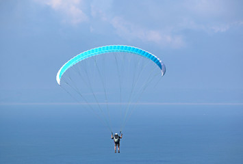 Paraglider flying above the sea