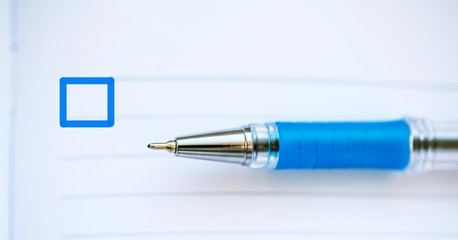 blue pen on a blank sheet of paper and a square check box
