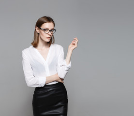 Portrait of the young modern business woman. The strict beautiful thin brunette with the equal...
