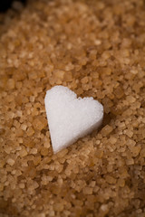 Various kinds of sugar in a wooden box. White refined, brown cane sugar collection