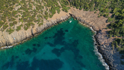 Fototapeta na wymiar Aerial view of small islet of Ydrousa with turquoise and sapphire clear waters and only one mile distance from coast in Voula, Athens riviera, Attica, Greece