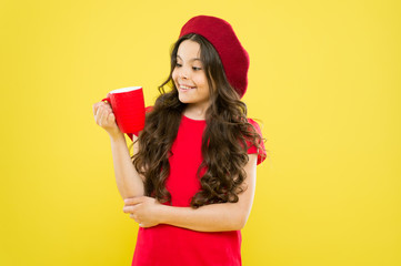 Girl kid hold mug yellow background. Child hold mug. Drinking tea juice cocoa. Relaxing with drink....