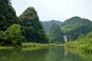 Fototapeta na wymiar River and karst mountains in Trang An in Ninh Binh, Vietnam.