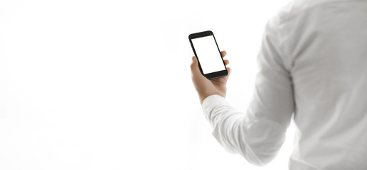 Man holding smart phone with green screen.