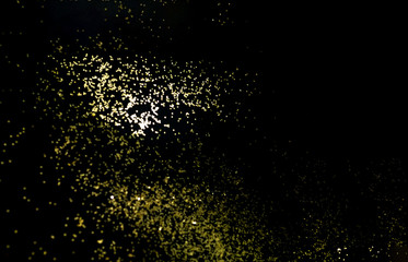 Black background with golden sparkles. Blurred  effect. Concept for festive background or for project.