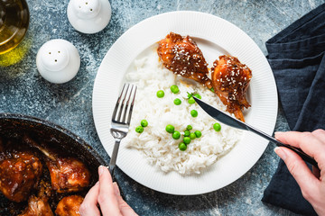 Roasted Teriyaki Chicken Thighs With White Rice And Green Peas On White Plate. Table Top View. Tasty Dinner Food
