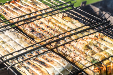 Friends making barbecue and having lunch in the nature.