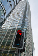 Traffic lights multiple exposure image. Traffic light showing red against of modern office block...