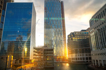 London, UK. Canary Wharf Banking and business area at  sunset. Lights reflection in the dock water. 