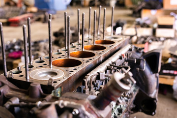 Mechanic opened the locking valve mechanism. Disassemble engine block vehicle. Old motor capital repair. Car service concept