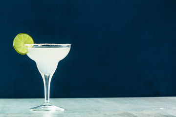 classic margarita cocktail on the table with bar accessories.