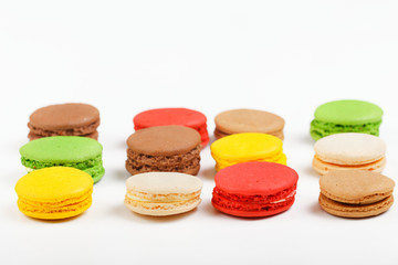 Macarons on a white background. Multicolored sweet macarons laid out in rows.