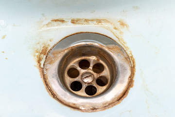 Dirty sink drain mesh, hole with limescale or lime scale and rust on it close up, dirty rusty...
