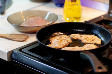 raw chicken meat on pan at kitchen. chicken chops. selective focus. cooking chops.