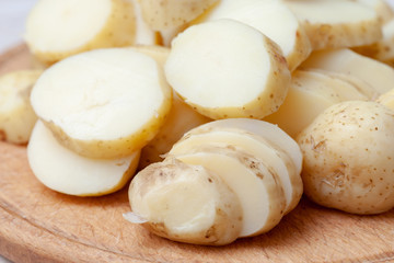 Fototapeta na wymiar sliced boiled potatoes on the kitchen board. ingredient for the dish.
