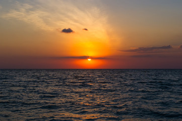 Fototapeta na wymiar Amazing sea sunset, the sun, waves, clouds