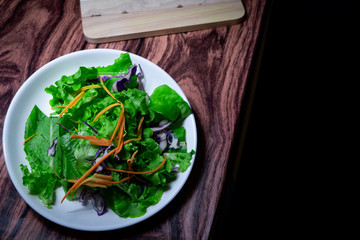 fresh organic Salad on table with window light. space for text. 