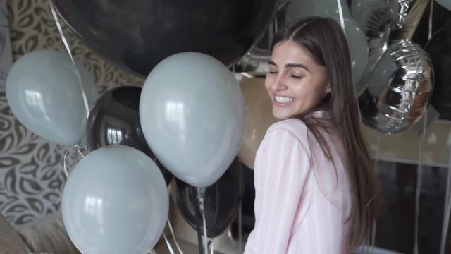 Pure joy of birthday celebration, woman posing with helium balloons