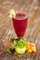 Fresh organic beetroot smoothie in the glasses with ingredients around	