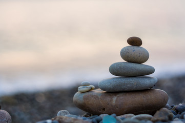 Fototapeta na wymiar stack of zen stones on pebble beach