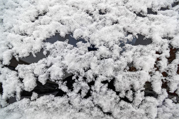Snow on the surface of the car glass