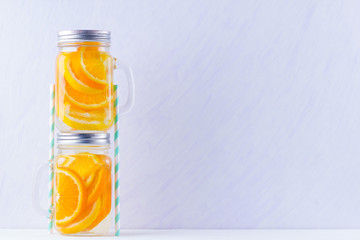 Infused water with fruits on white background. Mug delicious refreshing drink of mix fruits on white background. Iced summer drink in mason jar. Minimalism
