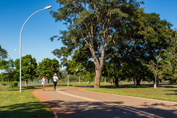 Mother and daughter play outdoor sport in city park