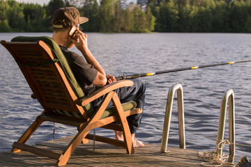 Mature man fishing from gangway