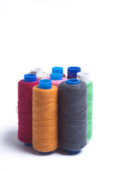 Spools of thread standing vertically on white background