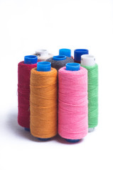 Spools of thread standing vertically on white background