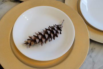 pine cone decorations as a holiday place settings