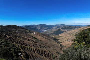 Fototapeta na wymiar View of Douro Valley with the Pinhao village, terraced vineyards and the Douro River, in Portugal; Concept for travel in Portugal and most beautiful places in Portugal
