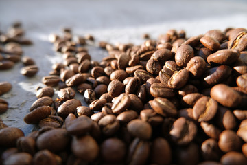 Aroma background made of coffee beans on sun light with copyspace. Beverages, morning and cafe concept