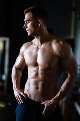Fototapeta na wymiar Strong, fit and sporty bodybuilder man over black background.