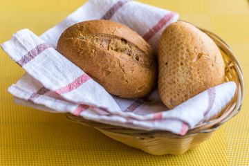 Two buns in a basket on the table in the restaurant.