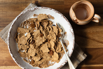 Healthy breakfast cereal; wheat bran flakes and dried sultanas with milk.
