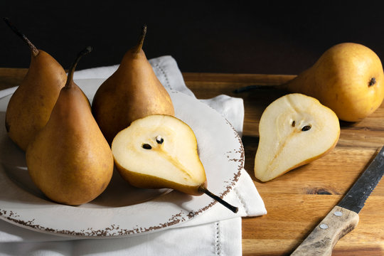 Ripe juicy pears on a rustic wooden table.