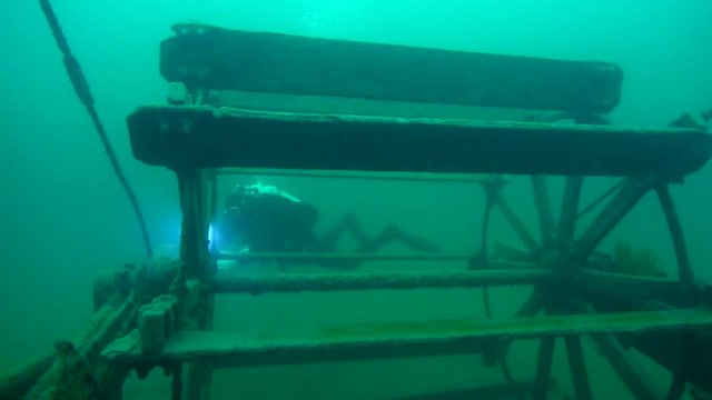 Scuba diver explores the paddlewheel on goldrush ship AJ Goddard