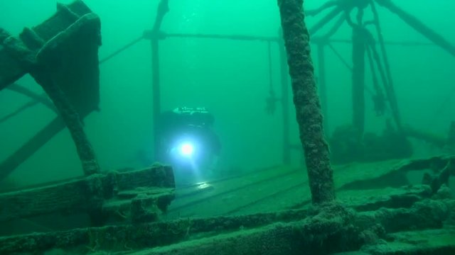 Scuba diver explores the stern of goldrush paddlwheel AJ Goddard