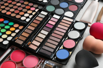 Set of different professional makeup products on table