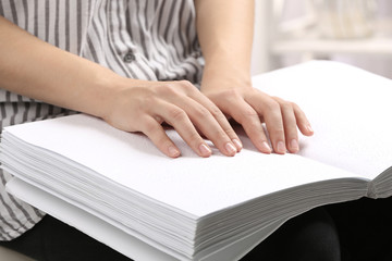 Blind person reading book written in Braille, closeup