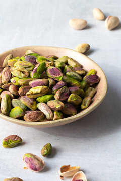 Roasted and salted pistachio nuts in a bowl.