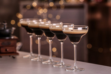 Glasses of delicious Espresso Martini on bar counter. Alcohol cocktail