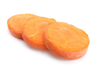Slices of fresh ripe carrot on white background